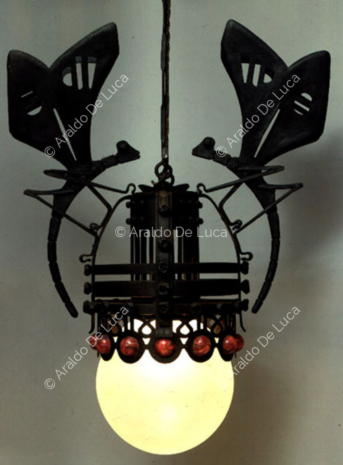 Chandelier surrounded by two large insects