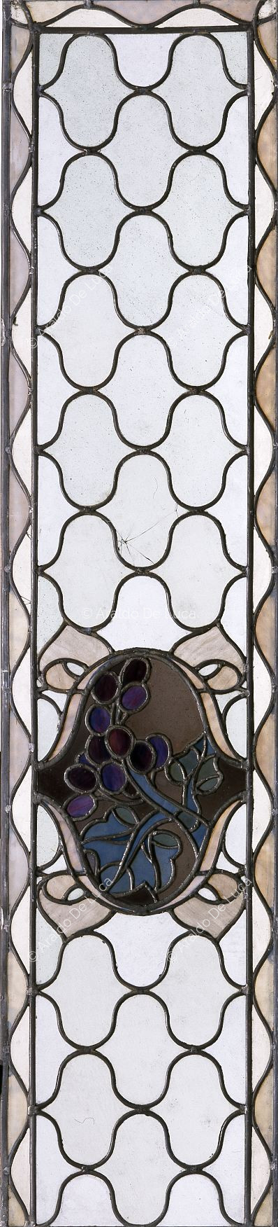 Stained glass with geometric motif and fruit