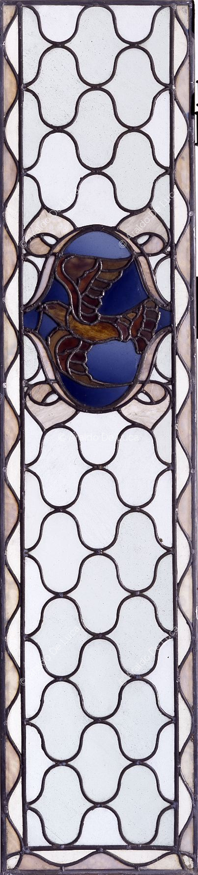 Stained glass window with geometric motif and dove