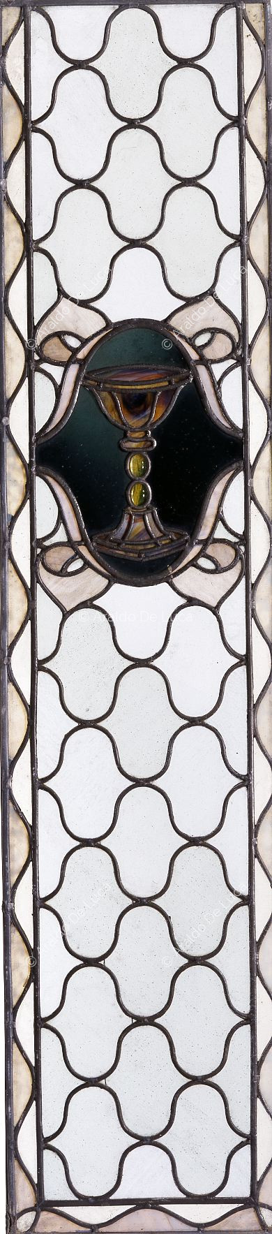 Stained glass with geometric motif and cup