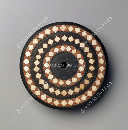 Inlaid disc with geometric pattern decoration
