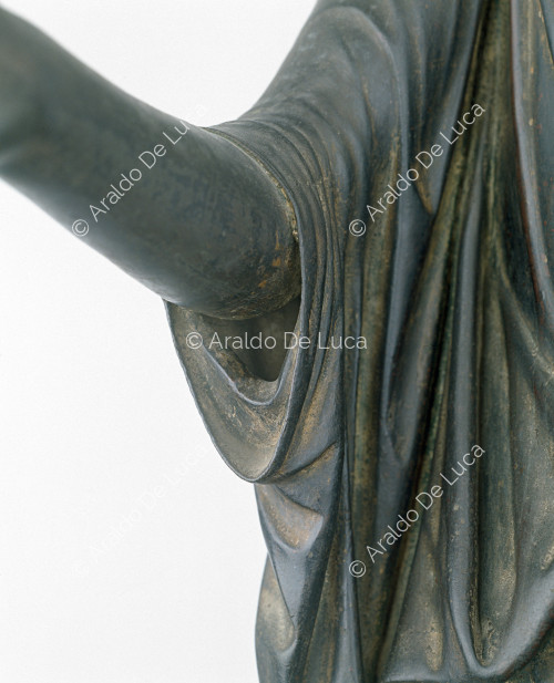 Female statue with raised arm