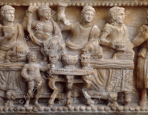 Etruscan cinerary urn. Detail of the chest with banquet scene