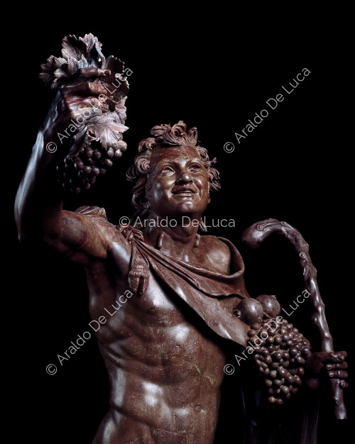 Estatua de Fauno borracho en rojo antiguo. Detalle del busto