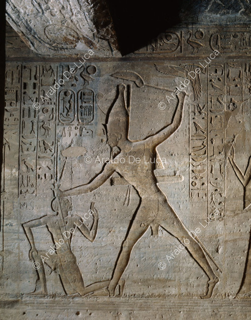 Rameses II massacres a Nubian in front of Amun (detail)