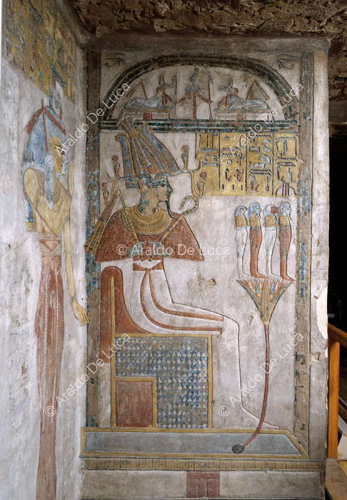 Osiris on a throne worshipped by Isis and Nephthys