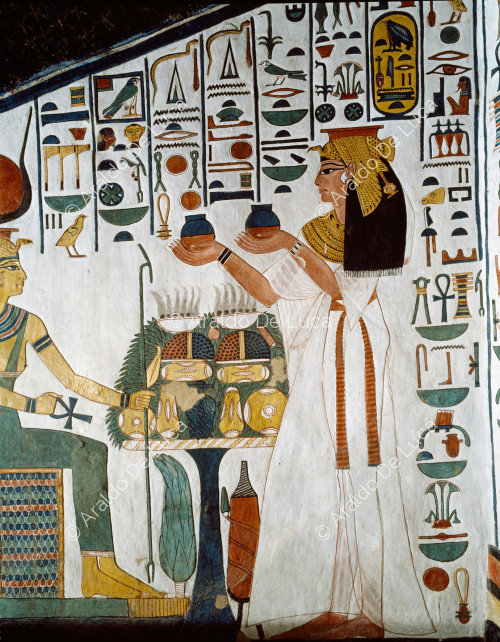 Nefertari offers the nemset jars to Hathor, Selkis and Maat