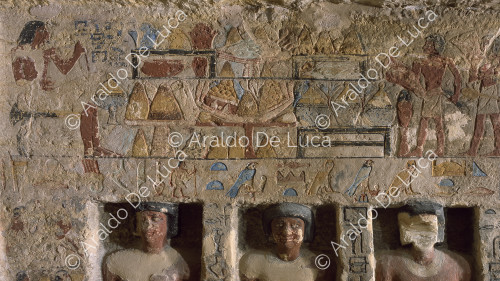 Wall decorated with paintings and sculptures