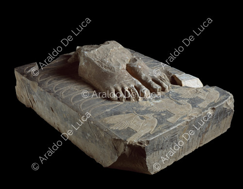 Fragment of the feet of the statue of Djoser on a plinth with hieroglyphics