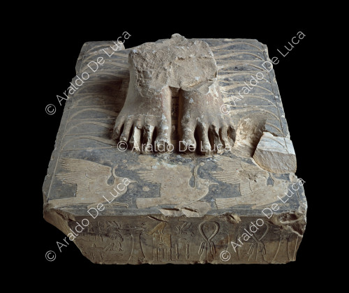 Fragment of the feet of the statue of Djoser on a plinth with hieroglyphics