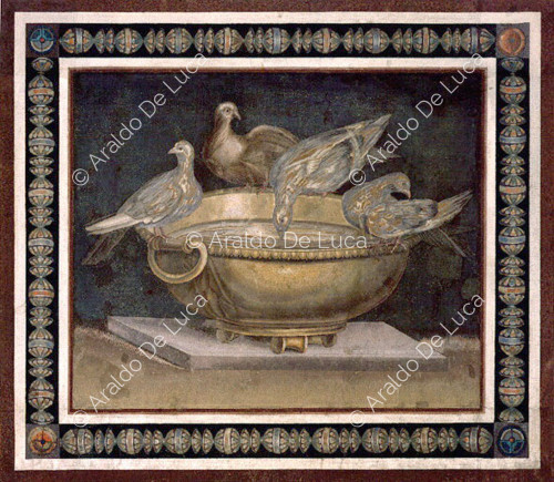 Mosaico con palomas regando un jarrón