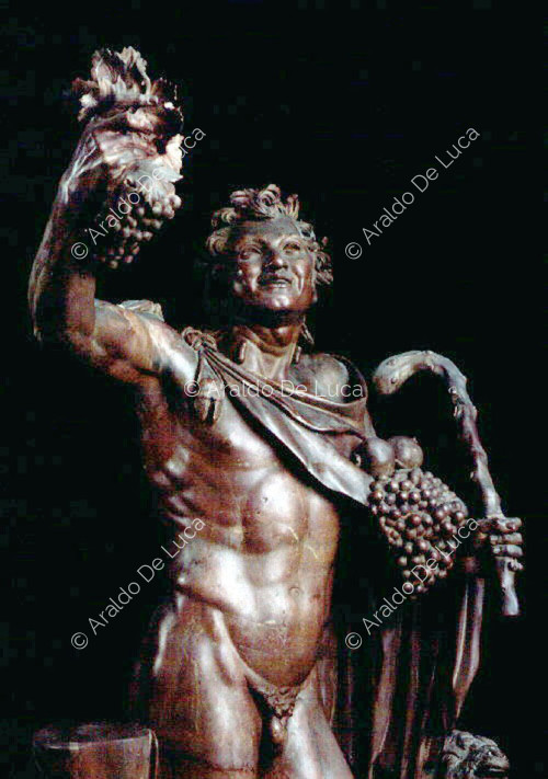Statue of drunken Faun in antique red. Bust detail