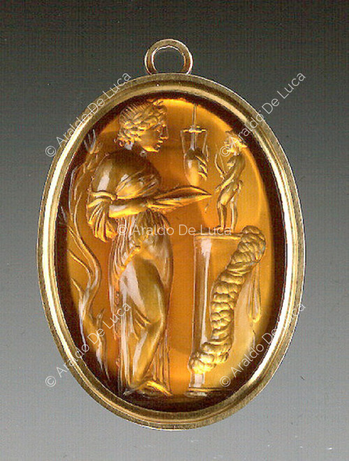 Medallion with priestess in front of a statuette of Apollo