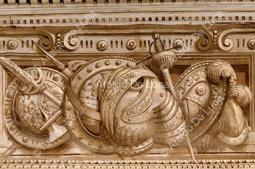 Monochrome frieze. Detail depicting weapons and armour