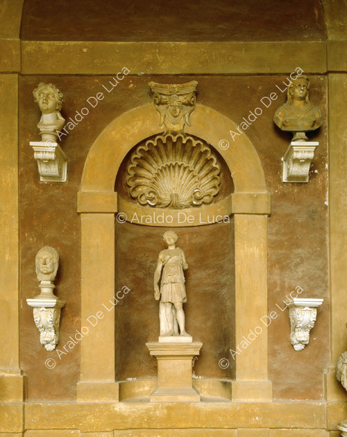 Niche with statue and heads