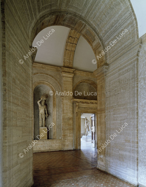 Corridor of the piano nobile with the entrance to the Hall of Hercules
