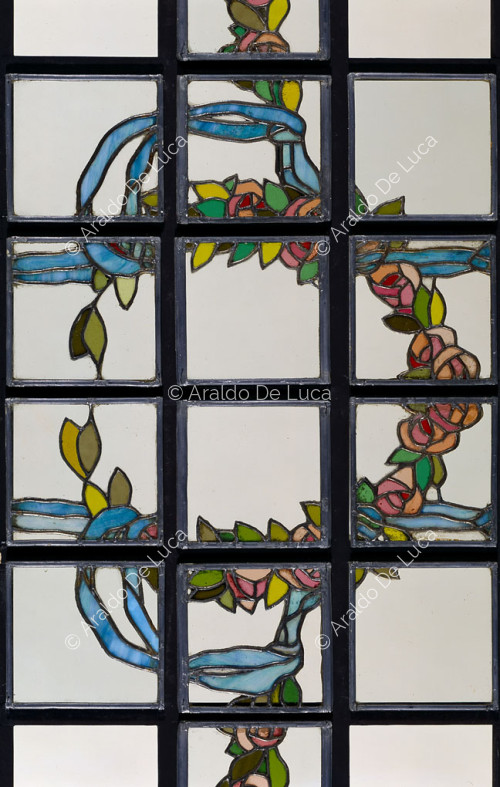 Stained-glass window with flower and ribbon