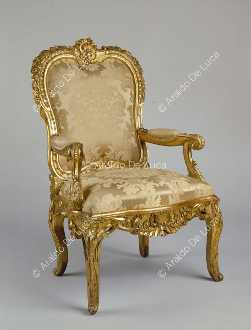 Carved, sculpted and gilded wooden armchair