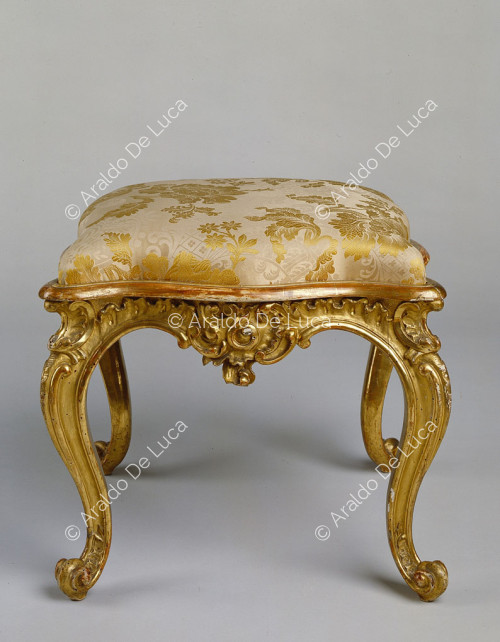 Upholstered and gilded stool