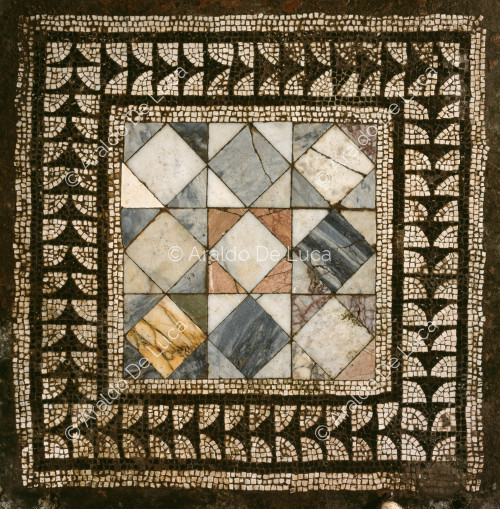 House of the Wounded Bear. Floor mosaic with emblem