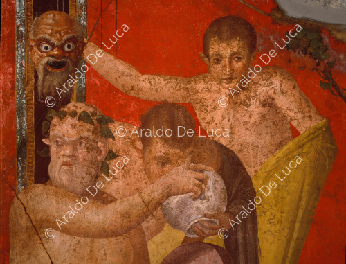 Villa der Mysterien. Szene V, Silenus bietet einem Satyr ein Getränk an, während ein anderer eine Maske hält