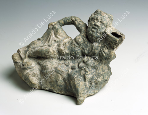 Clay statuette of Silenus lying down