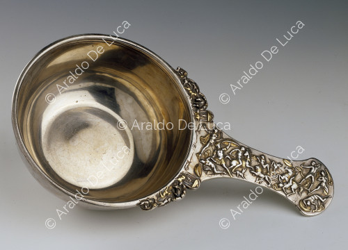 Silver receptacle with handle embossed with hunting scene