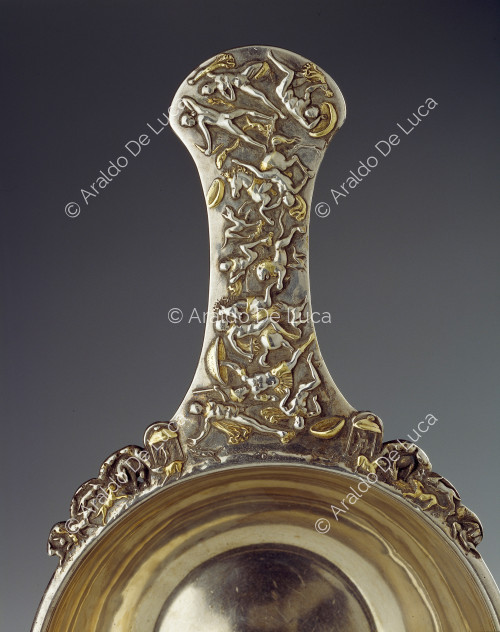 Silver receptacle with handle embossed with hunting scene. Detail of the handle.
