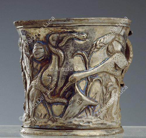 Silver cup with handle embossed with plant motifs