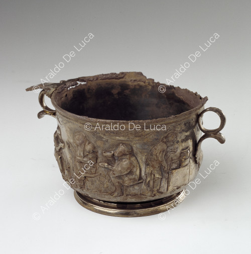 Silver cup with handles, embossed with figures eating