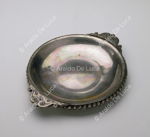 Silver plate with decorated rim and handles