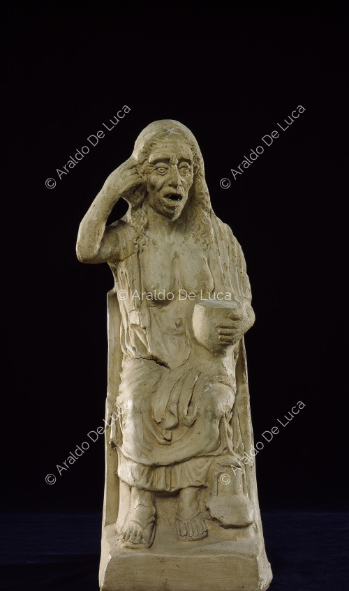 Pictorial statuette of a drunken old woman