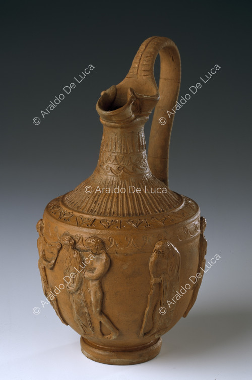 Pitcher with bearded mask and six human figures
