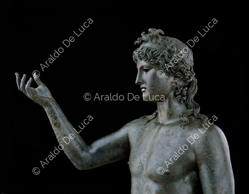 Nude bronze Dionysus. Bust detail