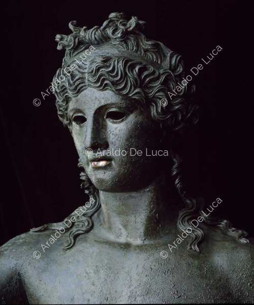Nude Dionysus in bronze. Detail of the face