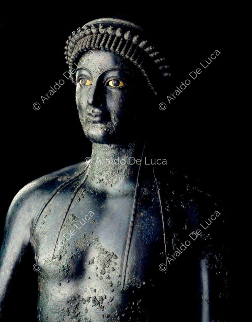Bronze statue of Apollo Lampadour. Bust detail