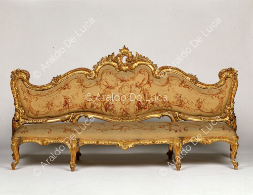 Upholstered and gilded sofa