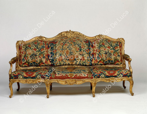 Upholstered and gilded sofa
