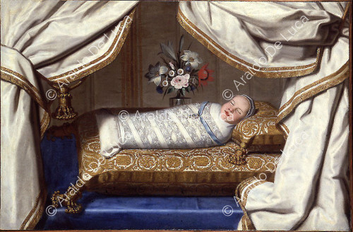 Baby in cradle with devotional cross